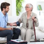 An elderly woman&#39;s blood pressure is taken